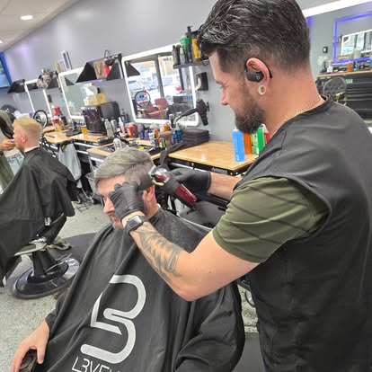 Barber giving a precision cut and beard at Tomasso's Barber